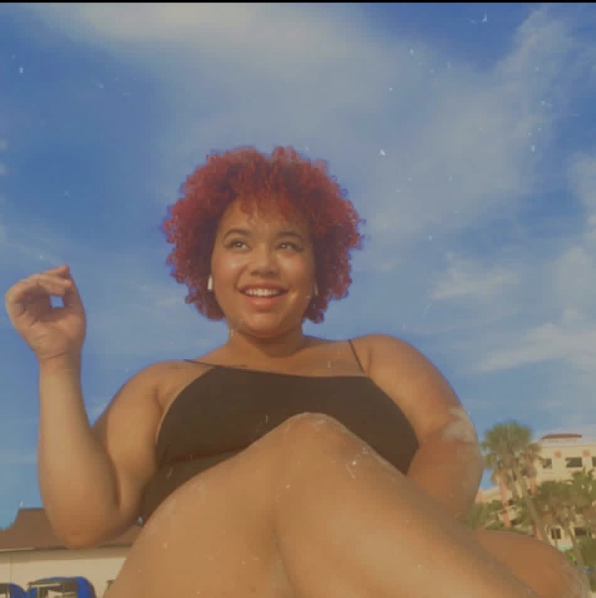Brie smiling beneath a bright blue sky